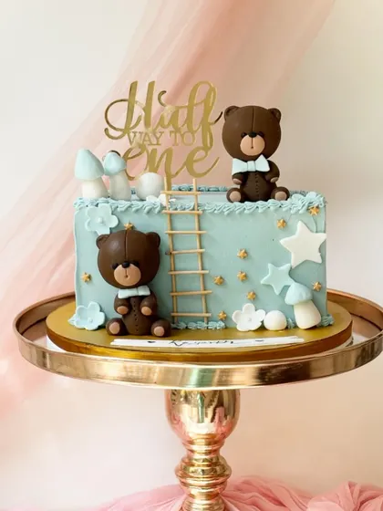 A "Halfway to One" cake for a six-month milestone. This rectangular cake is decorated with cute teddy bears, stars, and mushrooms.