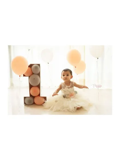A classic portrait from a first birthday studio session. The clean, bright background and simple props ensure that your little one is the star of the show.