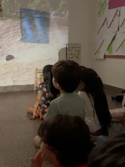 The children watch intently as a video is projected onto the wall. We use technology thoughtfully, as a tool to enhance learning and spark new avenues of inquiry and play.