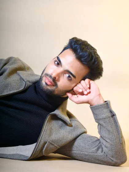 A relaxed yet intense portrait that plays with unconventional posing. This type of shot helps show a model's range and comfort in front of the camera, highlighting their features with soft, even lighting.
