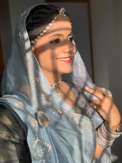 A sunlit portrait of bride Manisha for her Path function, looking serene and beautiful in her traditional attire.