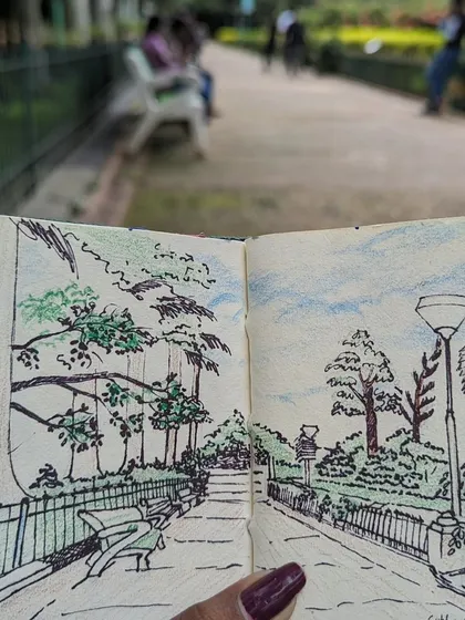 A close up of my Cubbon Park sketch, with the actual park path visible in the background. I've added touches of color to capture the greenery and the sky.