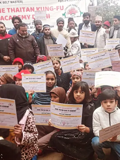 The entire group of students, young and old, showing their certificates of achievement. This is the community we build, where everyone's hard work is recognized.