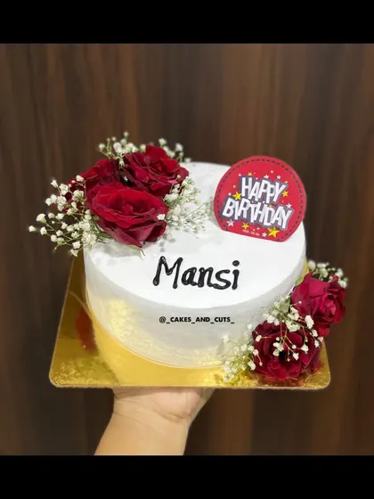 A simple yet beautiful birthday cake decorated with fresh red roses and baby's breath.