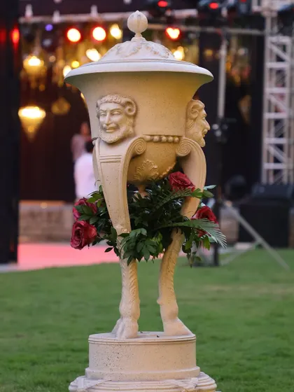A unique bar counter detail, using a classical-style urn as a decorative element for a sangeet.