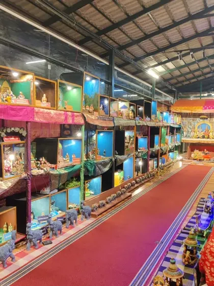A wide view of the doll displays at the Navaratra Mahotsava 2022. The red carpet leads visitors on a journey through dozens of dioramas, each telling a unique story.