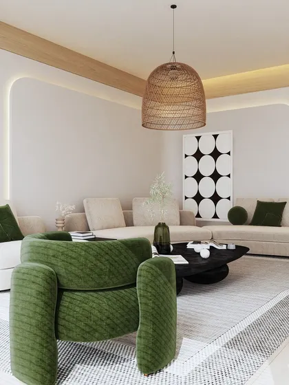 In this living room, we introduced pops of deep green to contrast with the neutral sofa and walls. A bold, textured armchair becomes a focal point, while a woven pendant light adds a touch of rustic, organic texture to the modern space.