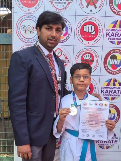 This young student earned his silver medal in kumite at the district championship, a crucial step towards bigger tournaments.