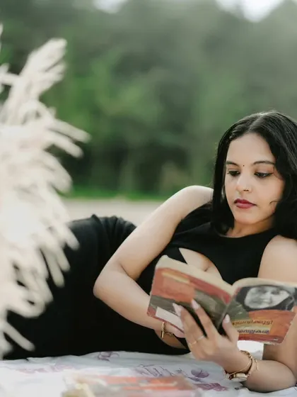 A unique pre-wedding concept with the bride-to-be relaxing with a book on a beach picnic setup.