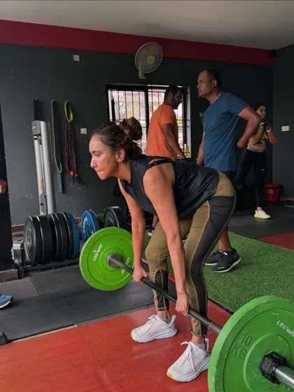 This client demonstrates excellent deadlift form, engaging her hamstrings and glutes to lift the barbell. I emphasize mastering these foundational lifts to build a strong, resilient body.