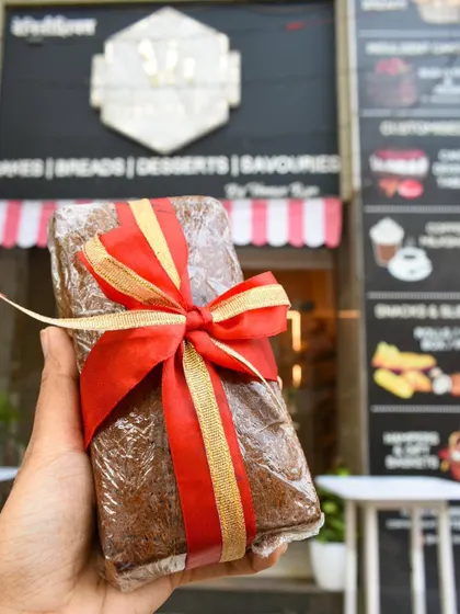 Our classic plum cake, wrapped and ready for gifting. It's a staple of our Christmas menu and a perfect holiday treat.