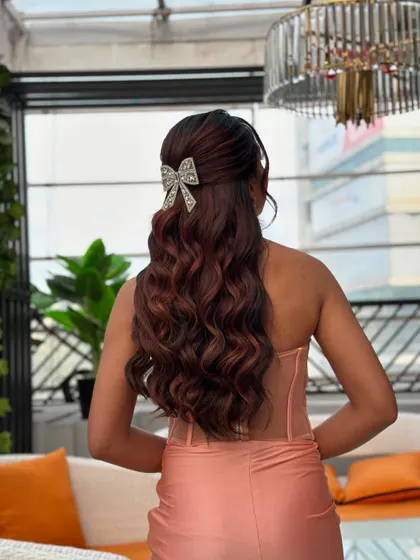 Another view of the glittering bow hairstyle, showing how it catches the light and adds a festive touch to the overall look.