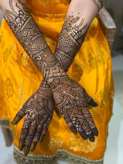 The back of the hands, adorned with intricate patterns that complement the front. This design features a mix of checks, florals, and leafy vines.