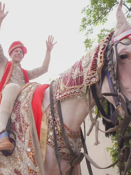 The groom's grand entrance on a beautifully decorated horse. This is a classic baraat moment, filled with energy and excitement.