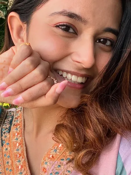 A happy client showing off her new pink ombre nails. It's a versatile look that complements any outfit.