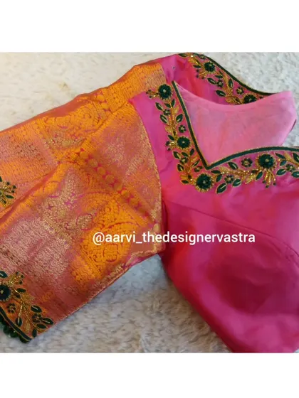 The full view of the pink blouse with its orange brocade sleeves, a vibrant and festive combination.