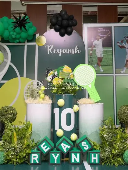 The main stage for a tennis-themed 10th birthday, designed to look like a tennis court with a net, rackets, and a vibrant green and black color scheme.