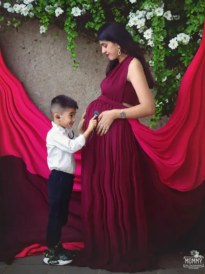 "I can hear your heartbeat!" This playful and sweet moment between a mother and her son during their maternity shoot is just too cute. It’s a memory they will both look back on and smile.