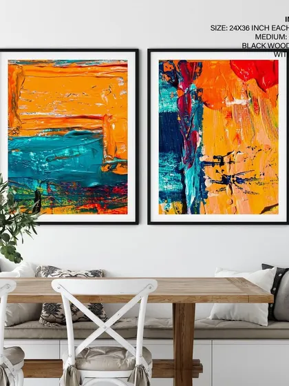 A close-up of our two-piece colorful abstract set in a dining setting. The black wood frames create a bold outline that makes the artwork stand out as a sophisticated focal point.