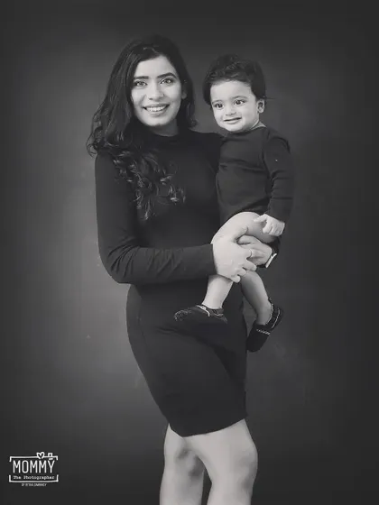 A beautiful black and white portrait of a mother and her son. Her smile is so full of love and pride. This is a classic, timeless image to cherish.