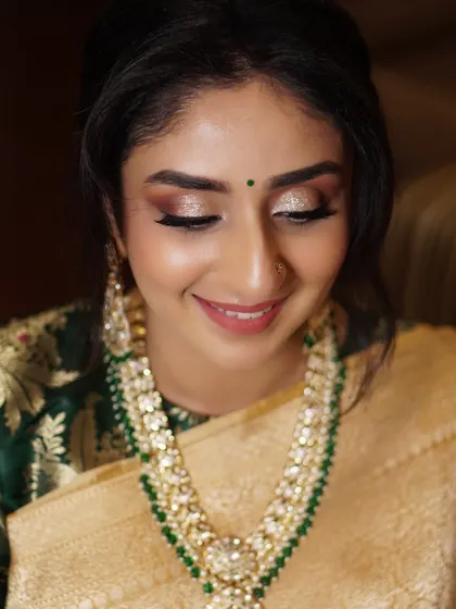 A stunning reception look for Aditi, designed to complement her beautiful gold and green saree. The warm, glittery eyes and glowing skin created a look of pure elegance and sparkle for her glamorous evening.