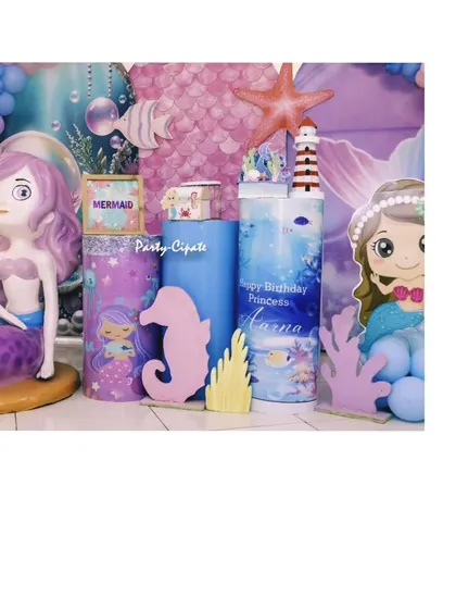 A closer look at the props for Aarna's mermaid bash, featuring a mermaid figurine and themed pedestals. Every detail is designed to fit the underwater fantasy.