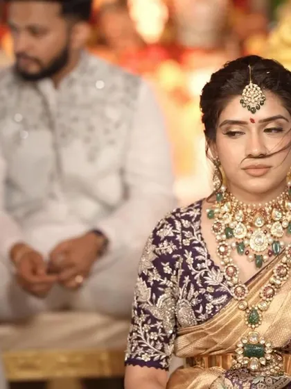A close-up of this bride's stunning engagement look. The intricate embroidery on her purple blouse is a beautiful contrast to her gold saree.