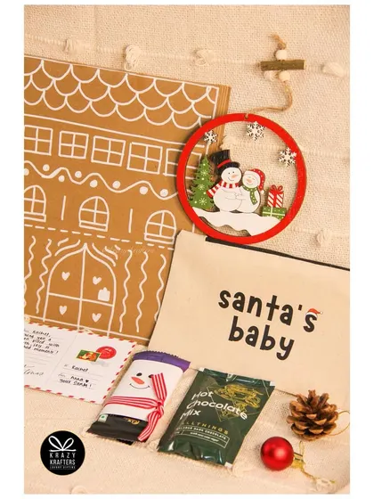 Our 'Merry Mail' Christmas gift set, designed to look like a gingerbread house envelope and filled with small treasures.