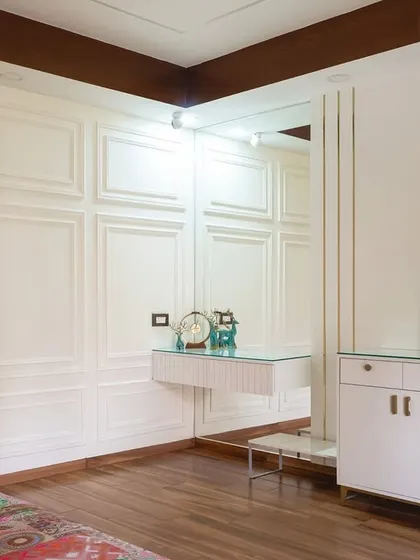 This room showcases classic elegance with its white paneled walls and clean lines. A floating vanity and modern abstract art add a contemporary touch, creating a space that is simple, stunning, and perfectly balanced.