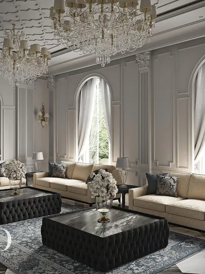Expansive arched windows allow natural light to illuminate the classical columns and detailed ceiling. The arrangement of multiple sofas creates an ideal setting for large-scale entertaining in a grand, yet comfortable, environment.