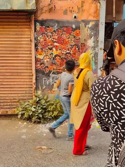 An artist's call to action on Chapel Road, Bandra. This paste-up collage of faces is an invitation for other artists to join in and turn the wall into a collaborative "urban gallery."