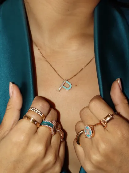 Here is the custom initial pendant paired with a matching ring stack. Personalization is all about creating a cohesive look that feels like you.
