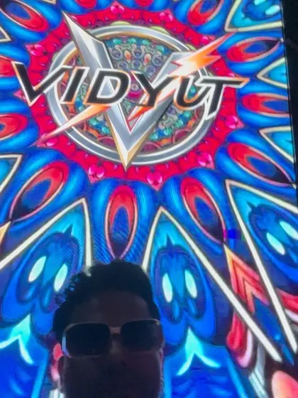 A selfie with my custom VJ logo displayed on the giant LED screen behind me. This branding is part of the visual package I offer for events.
