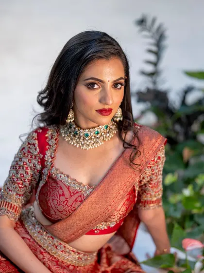 A direct, confident gaze. This shot highlights the perfectly executed red lip and the subtle contouring that defines her features.