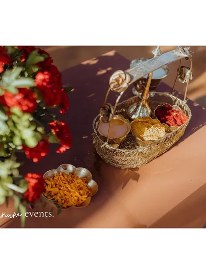 A close-up of the brass basket holding items for the puja, a small but significant detail.