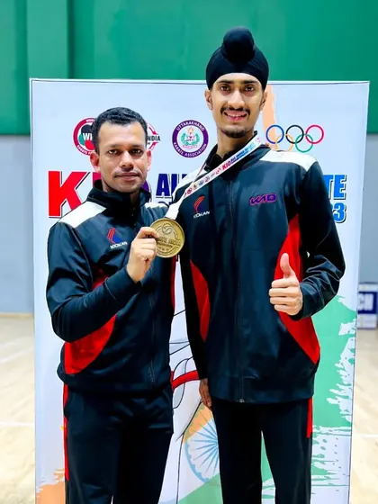 With my coach and our Silver medal from the Delhi Team event at the Nationals. We win and lose as a team.