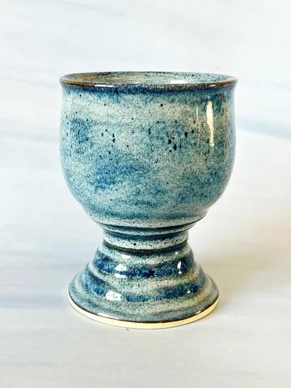 Sip in style with this handmade ceramic goblet. Thrown on the wheel and finished with a speckled blue glaze, it feels elegant and special.