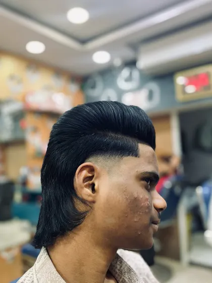 A clean shot of the finished mullet hairstyle. The top is styled for volume while the back is left with natural flow, connected by a smooth fade.