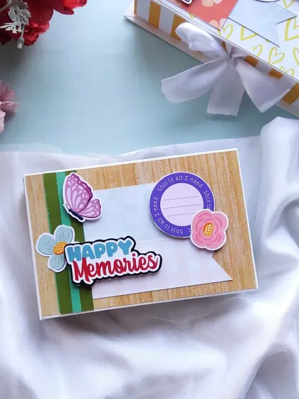 A mini album cover with "Happy Memories" and butterfly details, perfect for a small, personal gift.