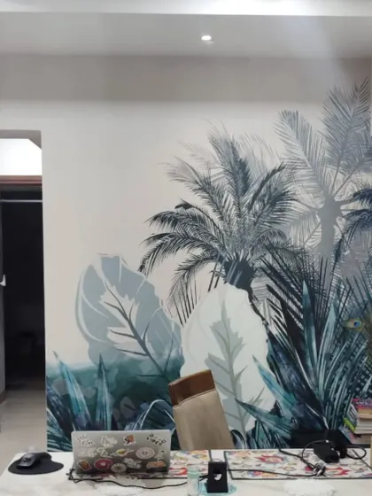 A blue-toned tropical leaf mural installed in a Powai home. The design adds a pop of color and a modern, natural vibe to the space.