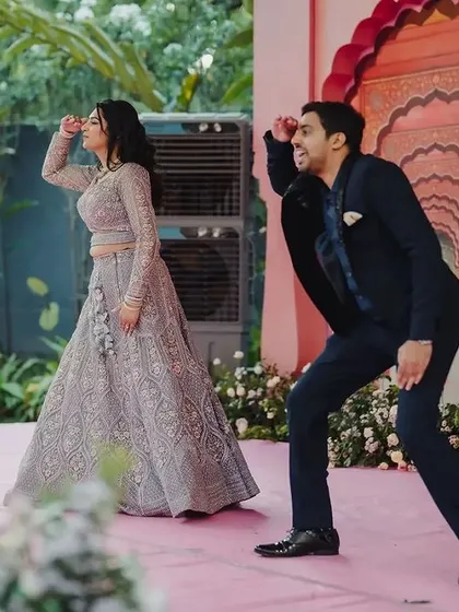 Amidst the grandeur of the Rajput palace-themed stage, the couple shares a playful dance. These are the candid, joyful moments that make a wedding celebration truly special.