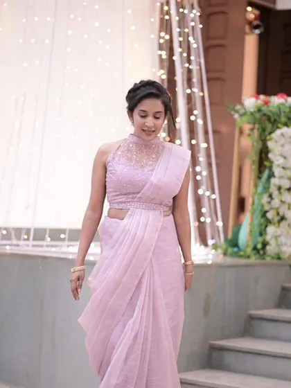 An elegant guest in a modern lilac saree. I gave her a sophisticated makeup look and a chic braided updo to match.