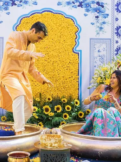 The couple sits in large traditional pots for their unique and colorful Haldi ceremony in Delhi.