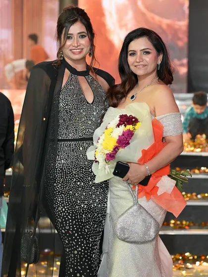 A candid moment between two attendees at a glamorous event. Event photography is also part of capturing the full story of a fashion or pageant night.