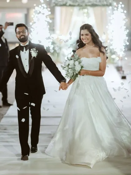 The grand entrance to the reception, with the couple walking hand-in-hand through a shower of petals and sparklers. A truly magical and cinematic moment.