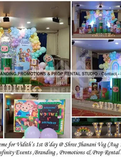 This elaborate Cocomelon first birthday at Shree Janani Veg features a pastel balloon arch, a custom backdrop with a rainbow, and multiple themed props and cutouts. The marquee letters spelling the name add a personalized and sparkling touch.