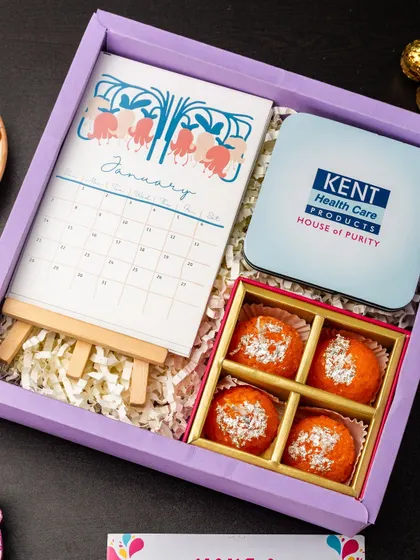 Another example of a branded gift for Kent, this hamper includes a custom desk calendar, a box of motichoor ladoos, and a branded tin, showing how I can incorporate your brand into festive gifts.