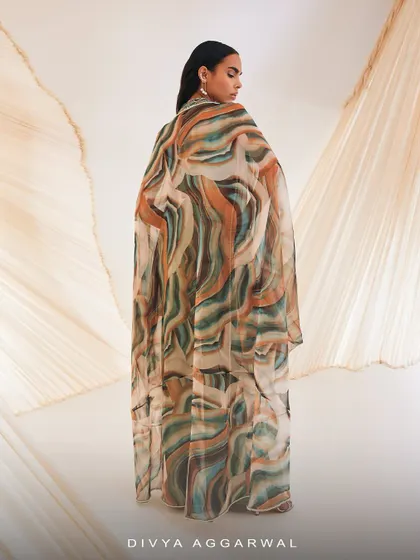 The back view of our Vivien cape set, showcasing the full expanse of the silky organza cape with its beautiful, abstract print.