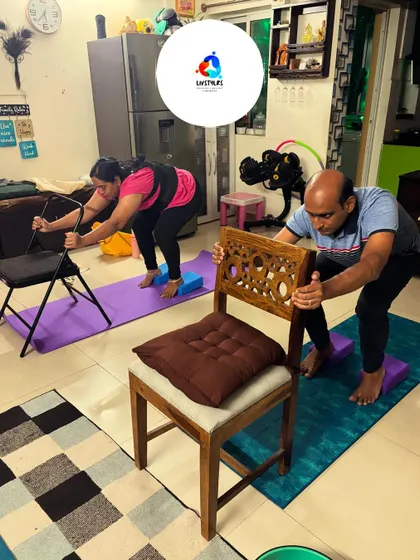 Clients use chairs to assist with back-stretching exercises, ensuring proper form and support. This modification helps improve spinal flexibility and relieve tension safely.