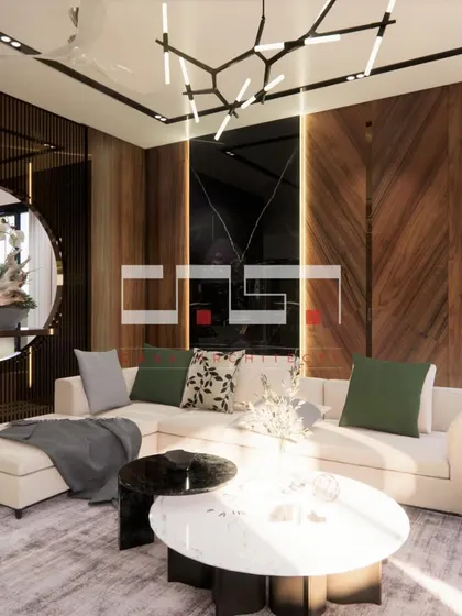 A close-up render of the living room, focusing on the chevron-patterned wood wall, modern chandelier, and comfortable sectional sofa.